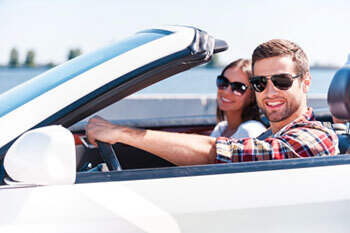 Couple driving in sunglasses