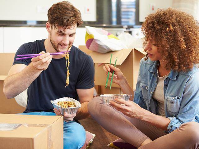 couple eating chinese takeout in their home