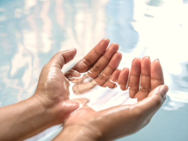 cupped hands holding water