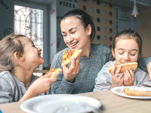 happy family eating pizza
