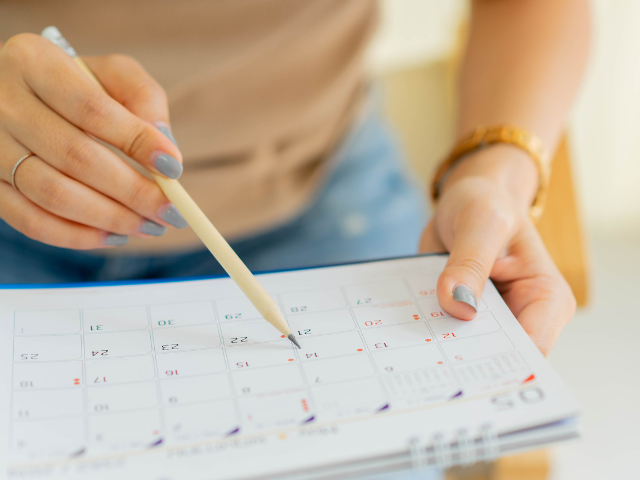 woman holding a calendar and planning