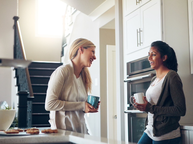 women smiling and talking and having coffee