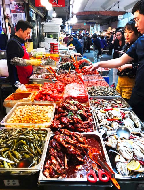 Food market with tourists in Seoul, South Korea.