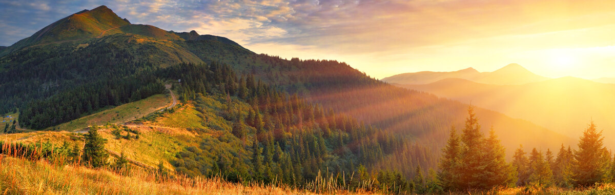 Inspirational sunrise over mountains and forests