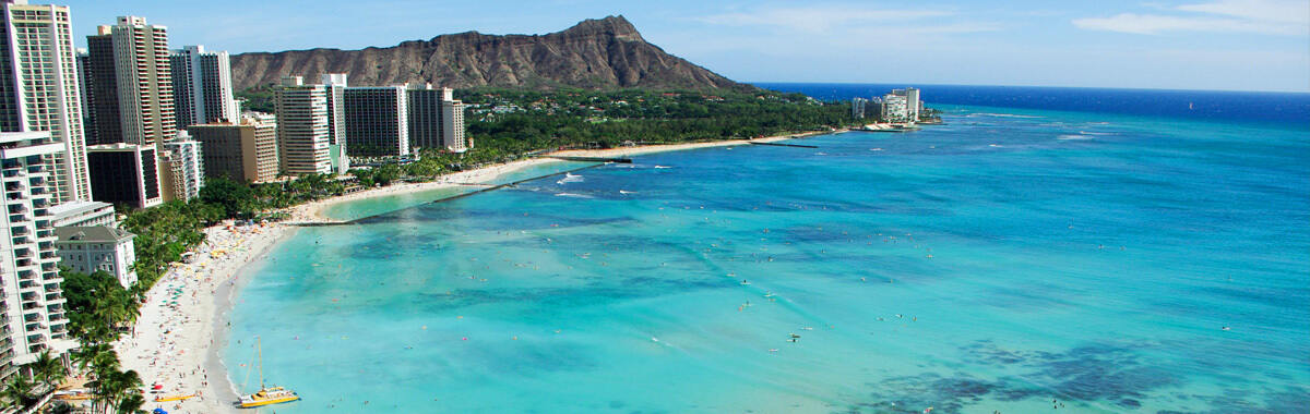 View from above looking down on hotels and tourists on Waikiki Beach and Diamond Head in Honolulu, Hawaii