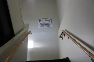 stairs with a sign that says entering needham pediatrics