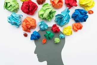 Paper flowers surround silhouette of brain
