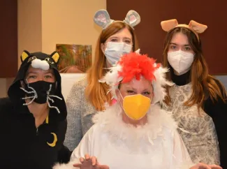 a group of women in mouse and chicken costumes