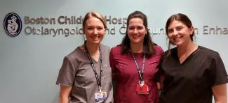 Audiology Program's 2022-23 extern class (3 women stand in front of Boston Children's Hospital Otolaryngology and Communication Enhancement sign)