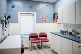 a fun pediatric exam room with fish decals on the wall
