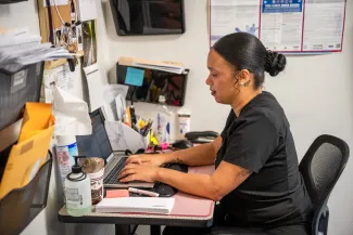 a medical professional at a computer