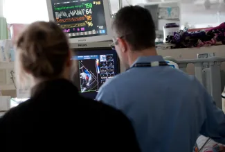 Clinicians look at numbers and imagery from a patient's heart