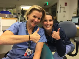 Two cardiology fellows give thumps ups