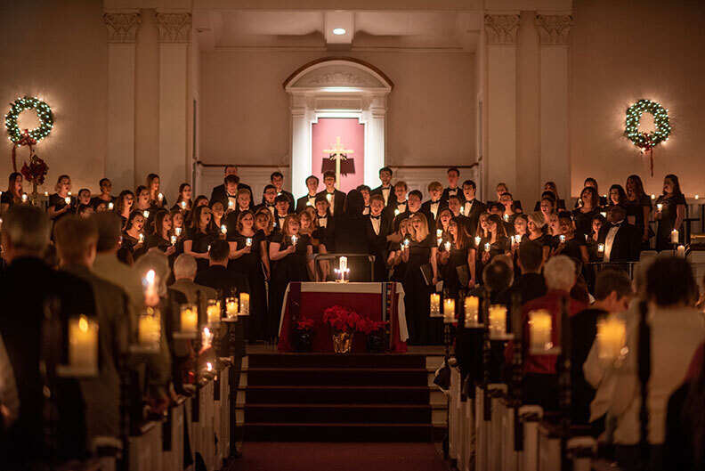 The candlelit aisle to the stage of Hammerschmidt Memorial Chapel, where the Elmhurst University choir performs during the Festival of Lessons and Carols.