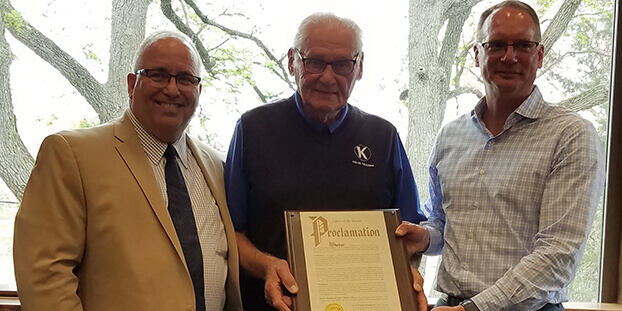Tom Keller and Bryan Keller holding Proclamation from Mayor Mike McCann on the release of Tom Keller's memoir, The Life & Legacy of Thomas E Keller 