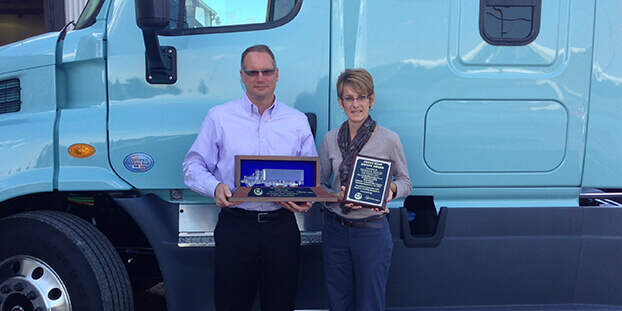 Bryan Keller and Beth Woodbury holding Ohio Trucking Association President's Award and Great West Safety Award in 2017 