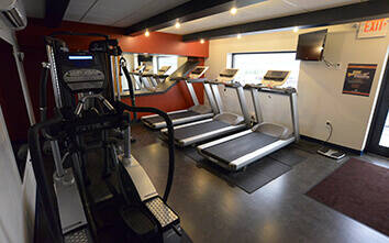 Fitness room at Keller Logistics Group with treadmills, elliptical and weight machine