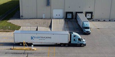 Keller-Trucking-truck-docked-in-warehouse-and-another-pulling-into-facility