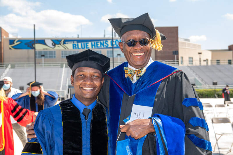 The shared joy of earning a doctorate is evident on the faces of John Wambui (left) and his adviser, Prof. Minion K.C. Morrison. Wambui, who grew up in Kenya, earned his doctorate in urban affairs and public policy.