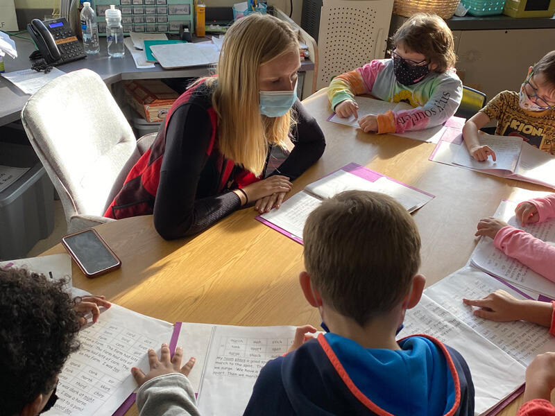 Ashley Rust, a first-grade teacher at Blades Elementary School, engages in a Bookworms lesson with her students.