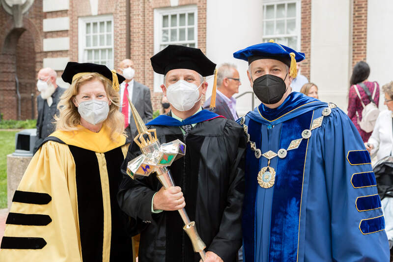 University of Delaware Provost Robin Morgan, Lou Rossi, dean of the UD Graduate College, and UD President Dennis Assanis pose for a group shot after the Doctoral Hooding Ceremony on the Green Thursday. Morgan will soon retire after 37 years of service to the University.