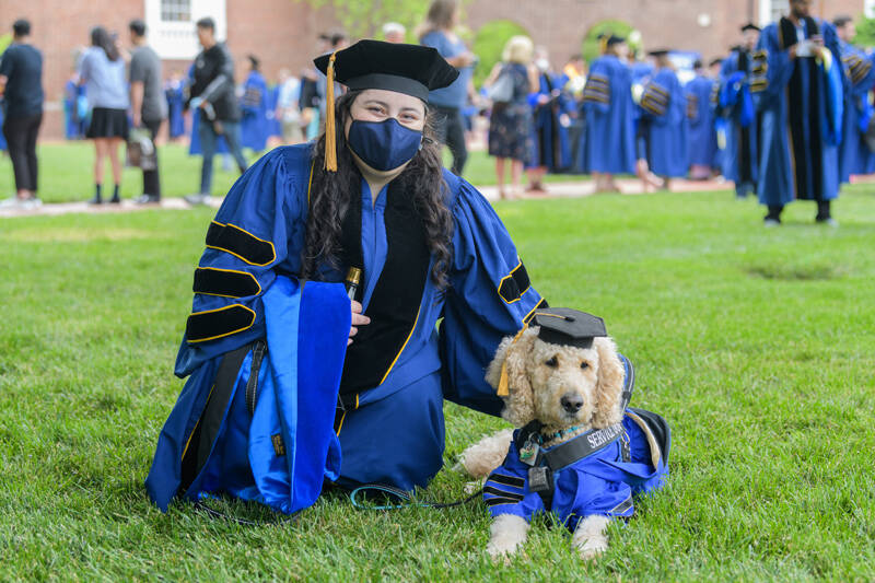 Fanny R. Mlawer and her service dog, Remy, show off their academic regalia after Mlawer received her doctoral hood. Mlawer’s doctorate is in psychology.