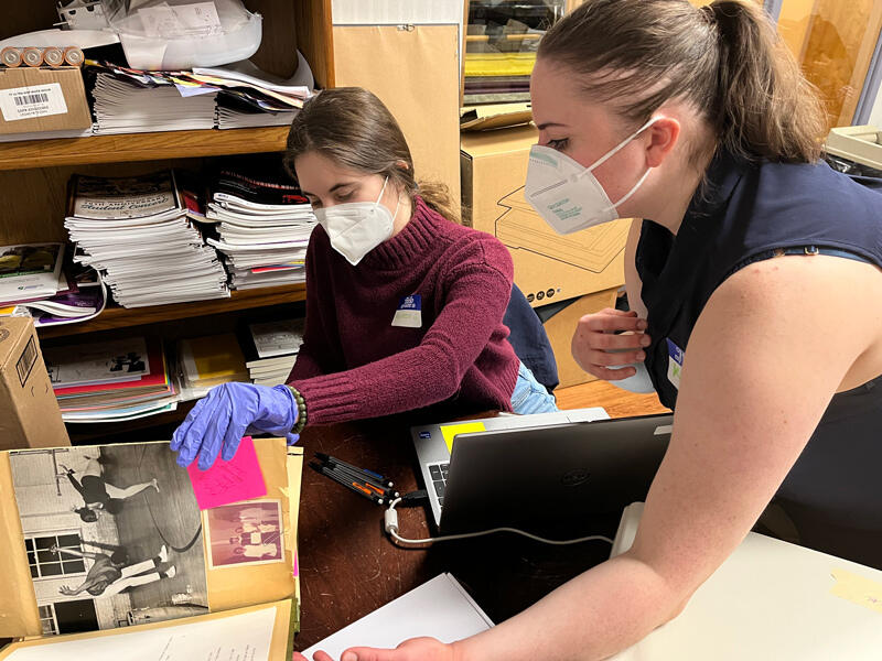 UD students Maureen Iplenski (left) and Kery Laws digitize material from scrapbooks at the Christina Cultural Arts Center in Wilmington.