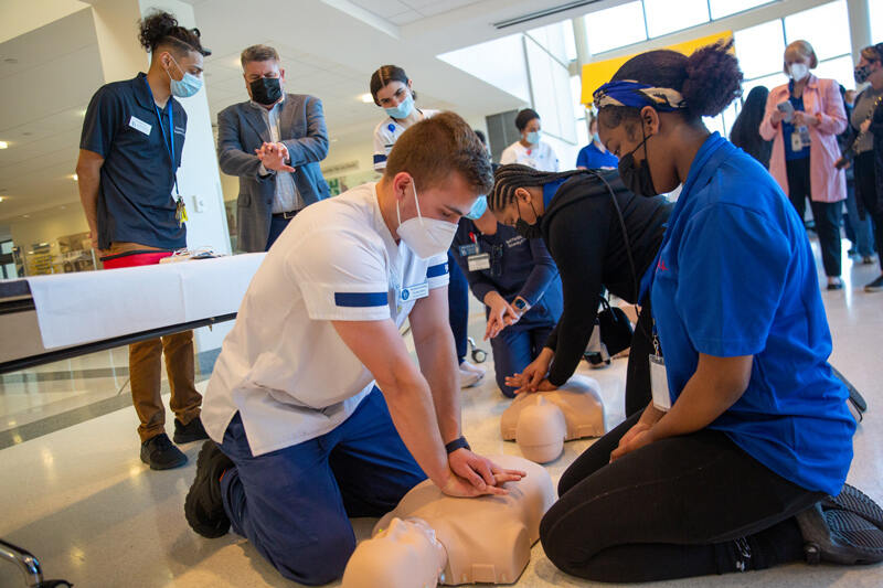 UD School of Nursing senior Ben Korleski, who is scheduled to graduate on Saturday, May 28, shows Brandywine School District middle school students how to properly administer CPR.