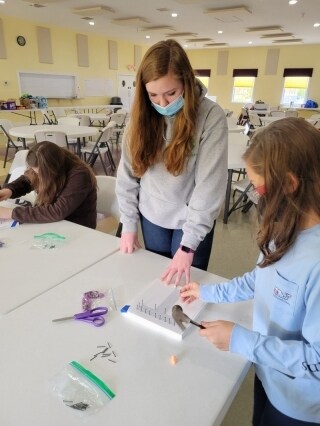 Ainsley West works with 4-H club members to create hand-crafted cards to send to U.S. service members.