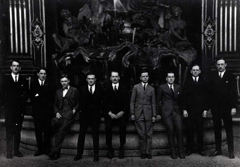 The first group of UD students to spend part of their junior year abroad posed in 1923 in front of the "Golden Gates" in the Place Stanis las Nancy. The town of Nancy is east of Paris, four to five hours by car. From left to right are David M. Doughery, Austin P. Cooley, John C. Snyder, Herbert H. Lank, Prof. Raymond Kirkbride, Francis J. Cummings, William K. Mendenhall, T. Russell Turner, John W. Walker. 