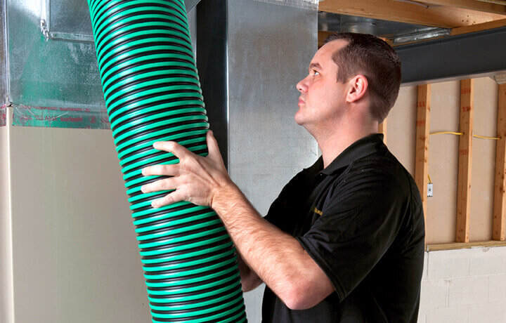 Stanley Steemer technician cleaning air ducts