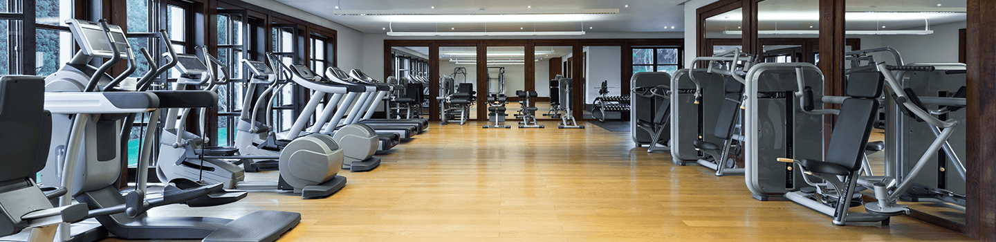 Fitness center with workout machines and hardwood floors