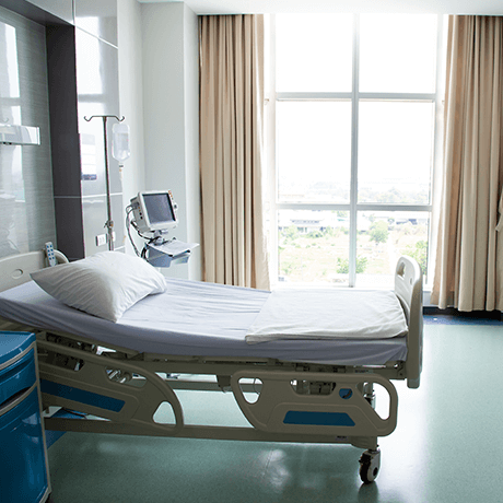 Patient room in hospital with bed and window