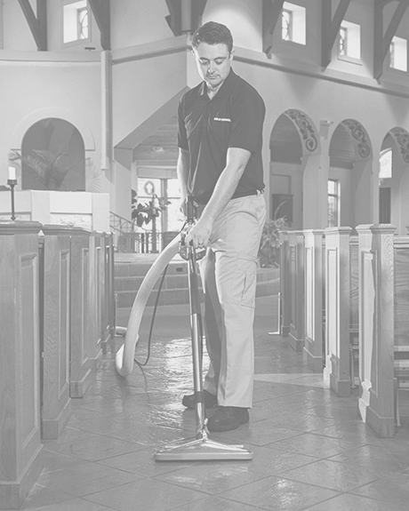 Stanley Steemer technician cleaning tile and grout in church