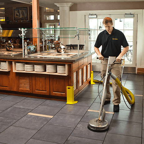 Stanley Steemer tech cleaning tile and grout near buffet at a restaurant