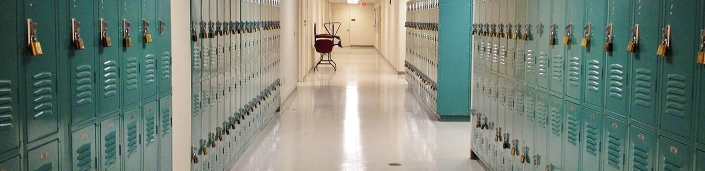 Turquoise lockers and VCT floors in school hallway