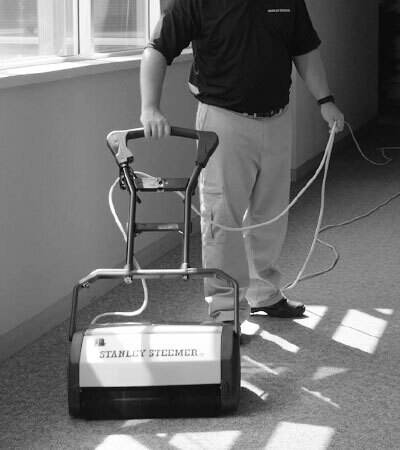 Stanley Steemer technician operating a CRB machine to perform an encapsulation carpet cleaning