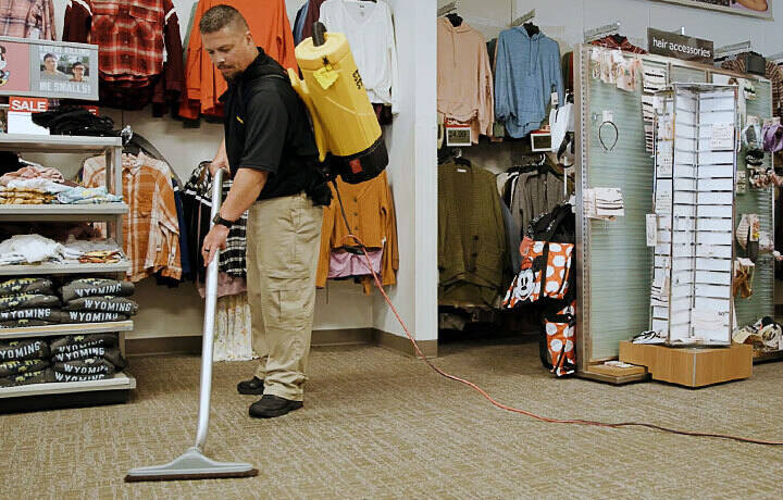 Stanley Steemer technician completing a spot vacuuming process as part of an encapsulation carpet cleaning service