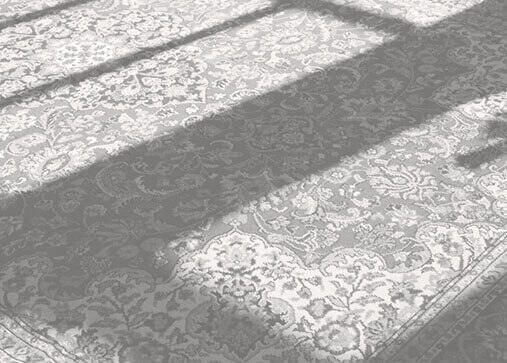 Clean oriental rug sitting on a floor. 