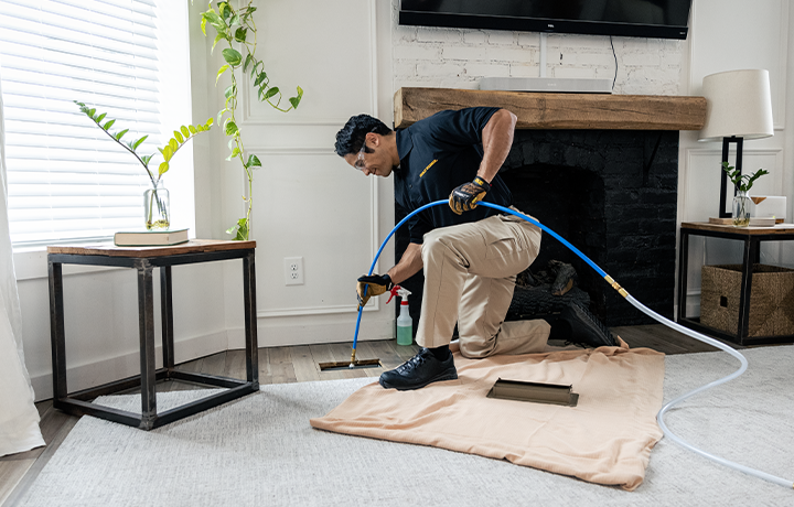 Stanley Steemer technician spring cleaning air ducts in home