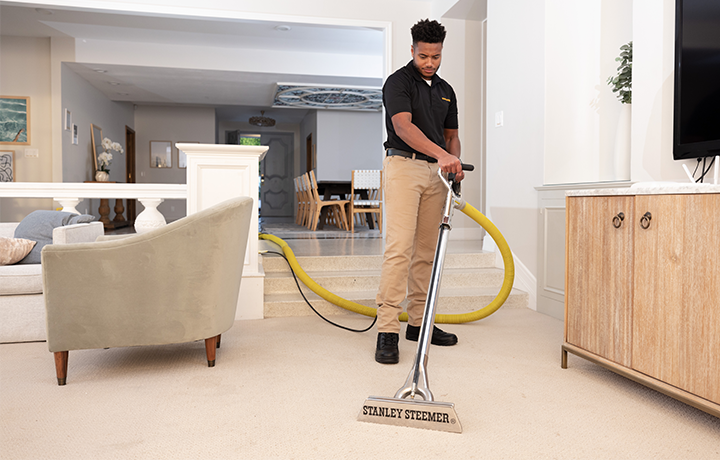 Stanley Steemer technician spring cleaning carpet in home