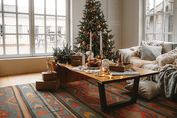 Festive living room showing a Christmas tree and couch