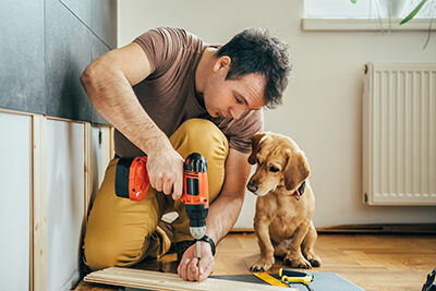 Man and his dog working on a home project