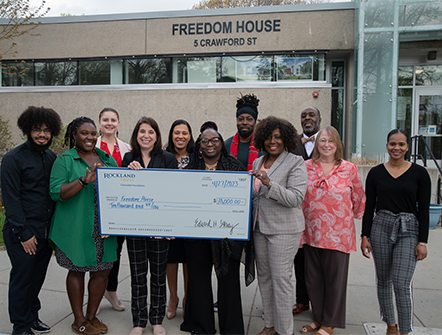 A group of members from Freedom House, recieving a large check from Rockland Trust's Charitable Foundation.
