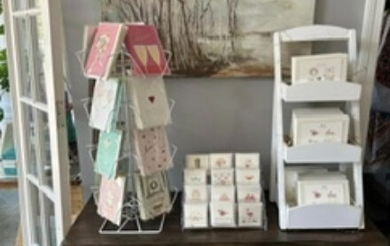 A display of greeting cards and stationary gifts sold by By the Sea.