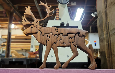Wooden moose animal puzzle sold by Completely Puzzled.