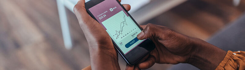 reviewing investing terms on a mobile device