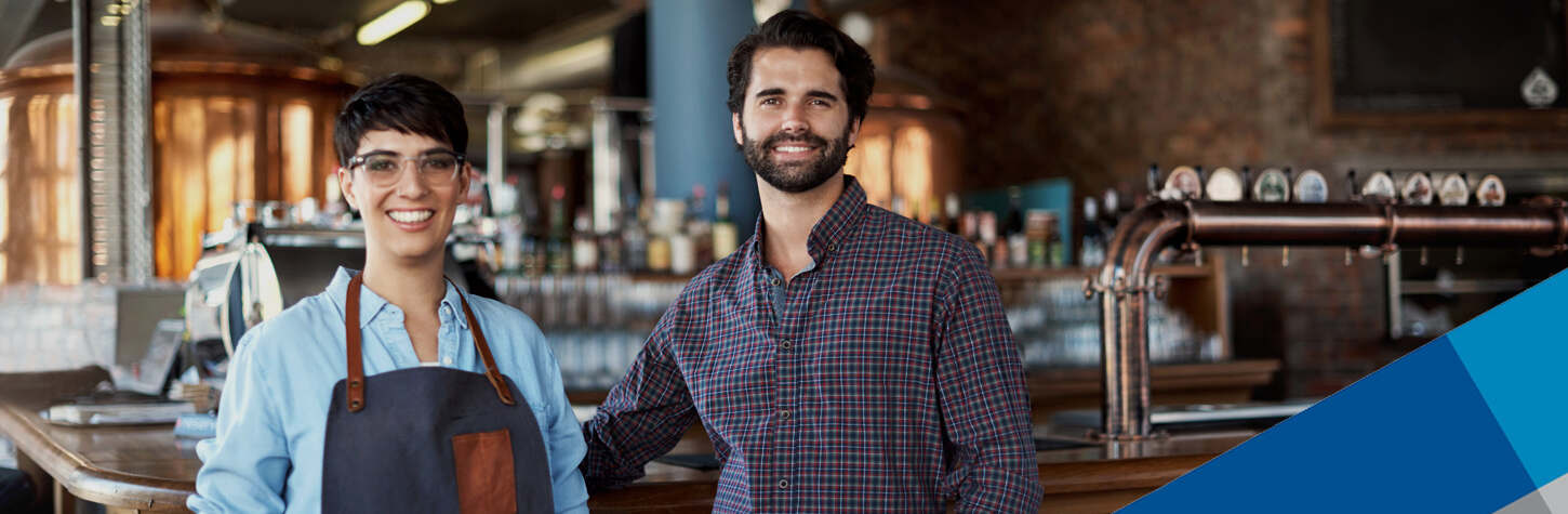business owners standing in front of a bar