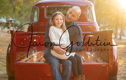 Father and daughter posing together for a photograph taken by Jason Goldstein photography.