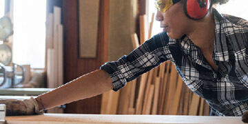 construction worker using sawmill